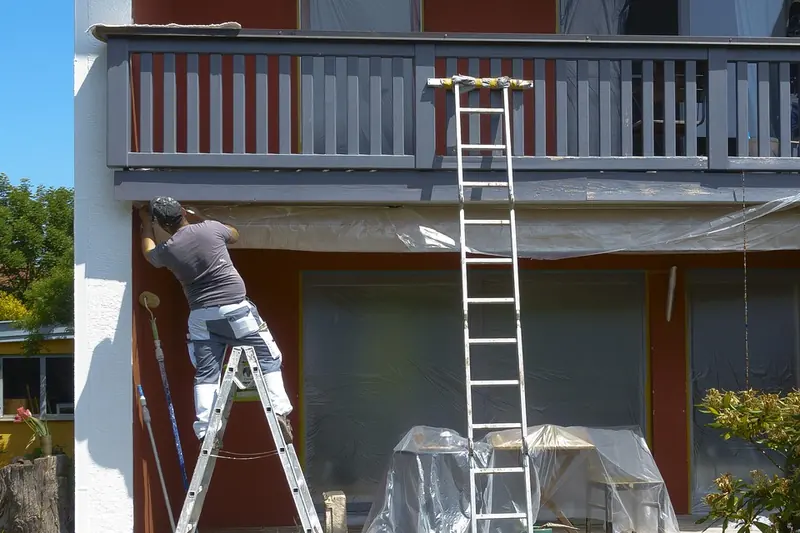 Exterior painting in Fremont: painter on a ladder painting house trim